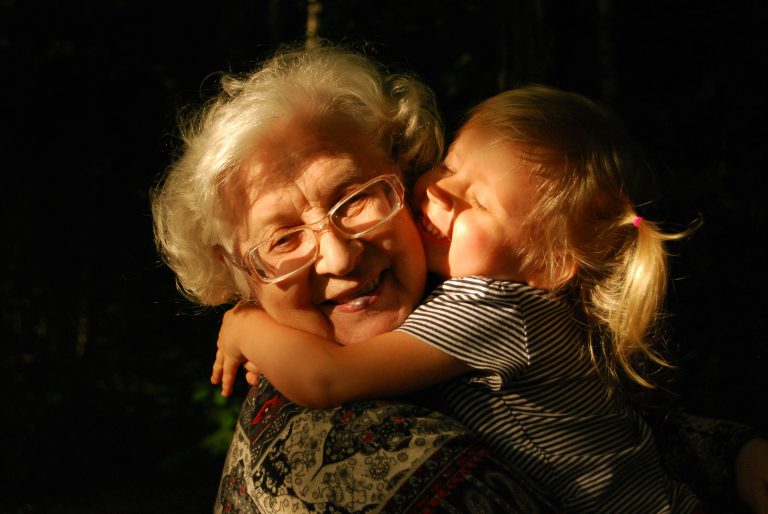 Grandmother and her grandchild hugging.